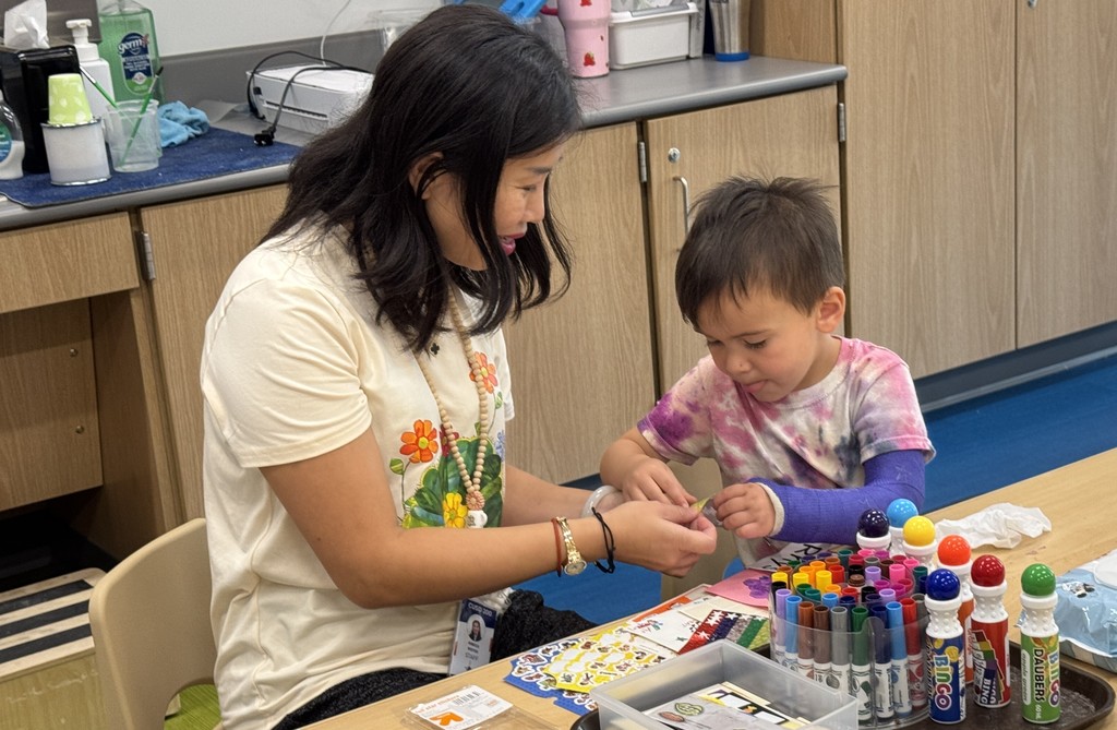 Teacher working with student