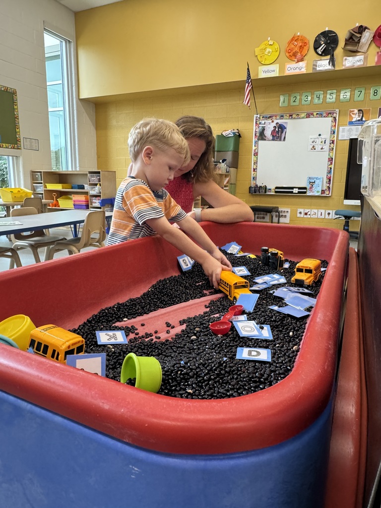 Boy playing in sensory bin