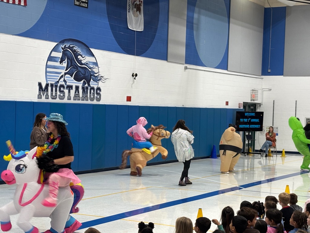 Teachers dancing on stage in costumes