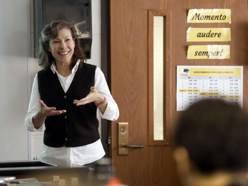 Teacher talking to students in a classroom