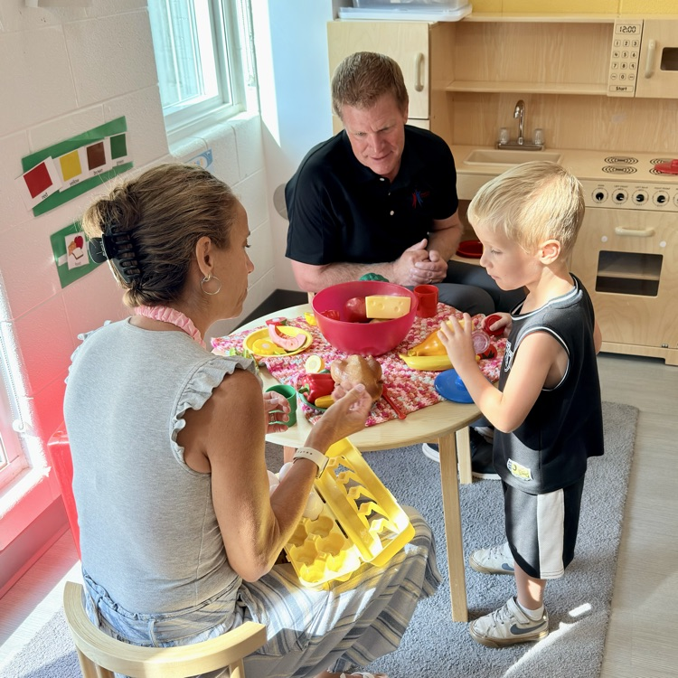 child playing with teachers