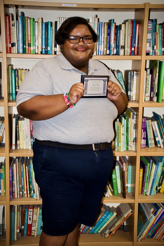 Destinee proudly showing her recognition plaque.