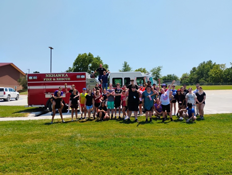 Band posing in front of fire truck  