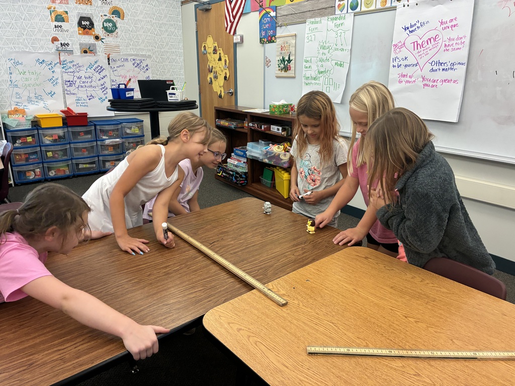 Students measuring wind up toys
