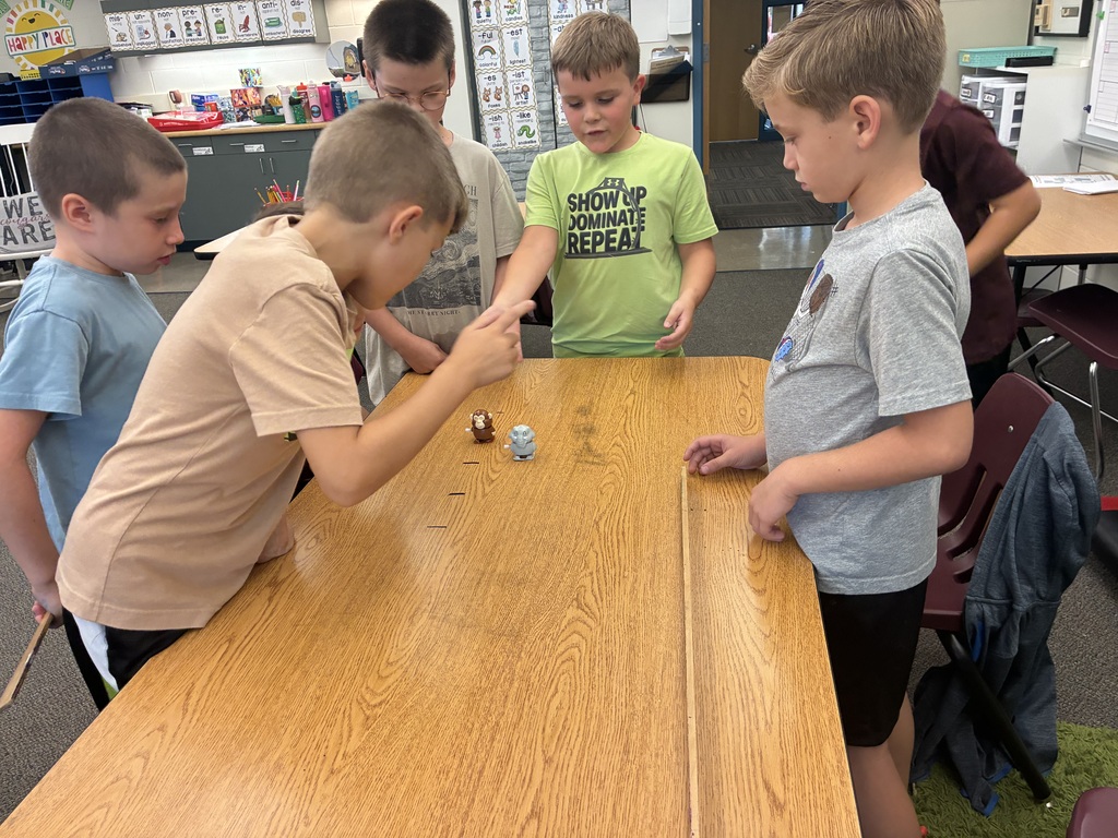 Students racing wind up toys