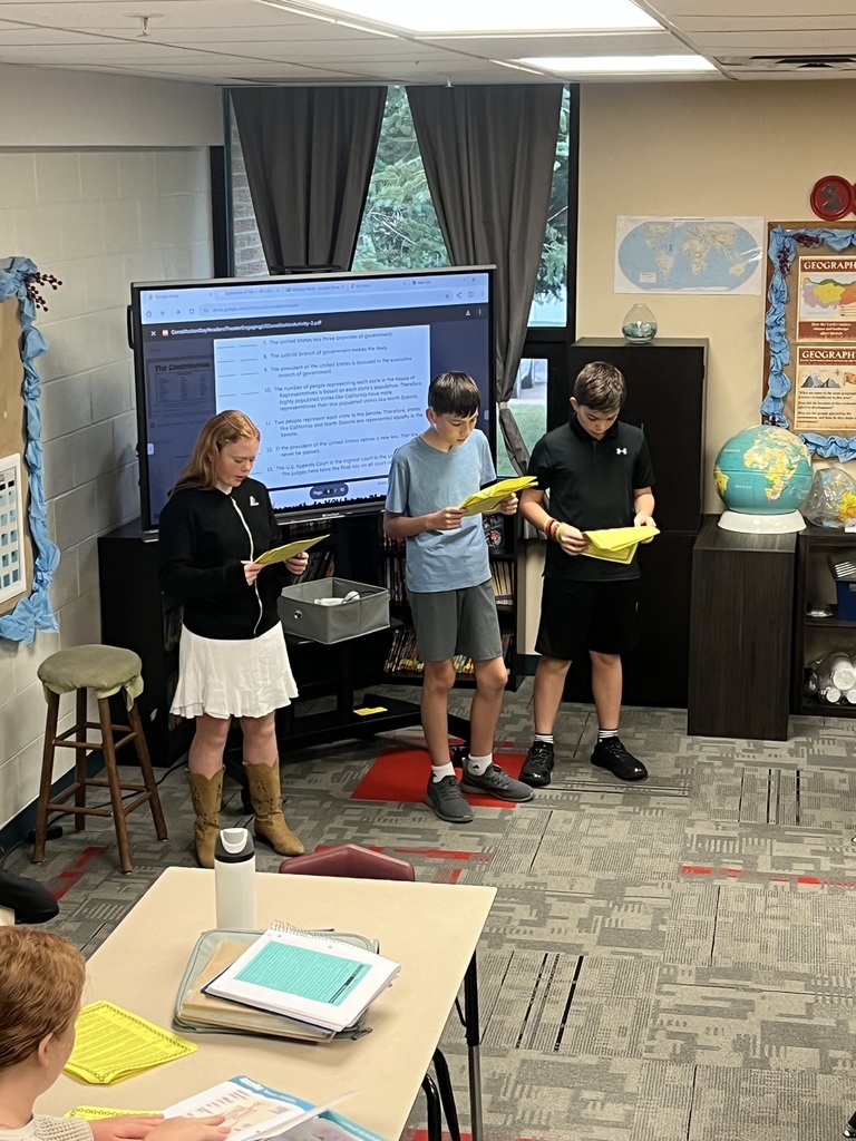 Students reading scripts for a Readers Theater
