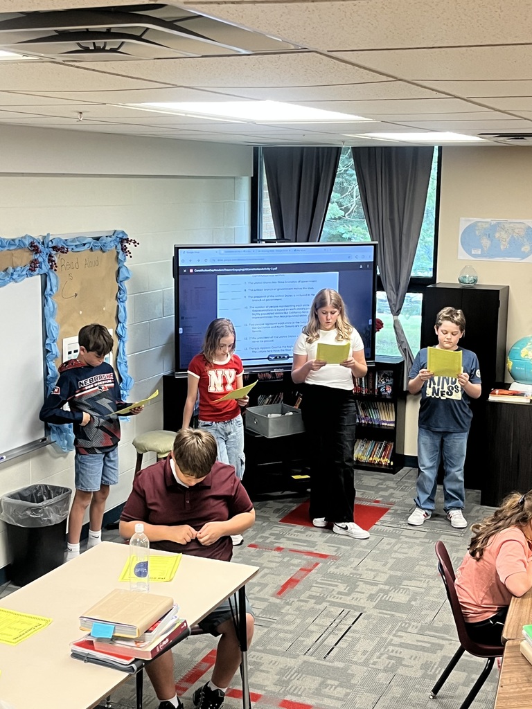 Students reading scripts for a Readers Theater