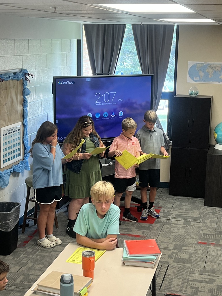 Students reading scripts for a Readers Theater