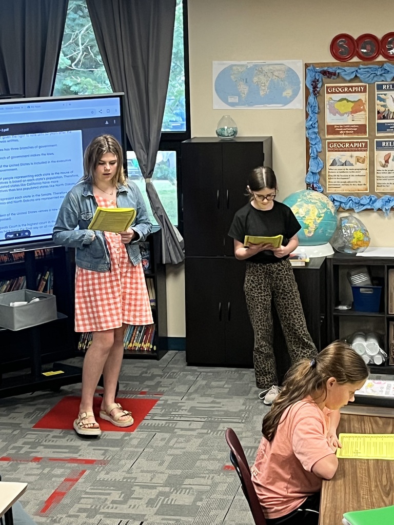 Students reading scripts for a Readers Theater