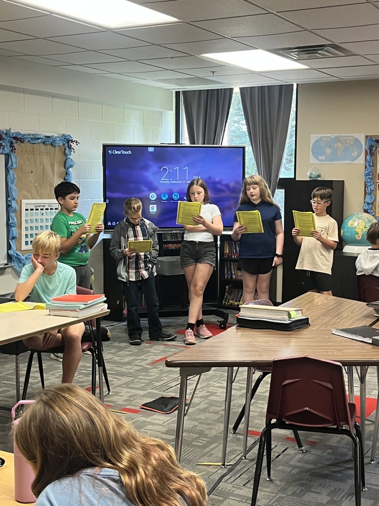 Students reading scripts for a Readers Theater