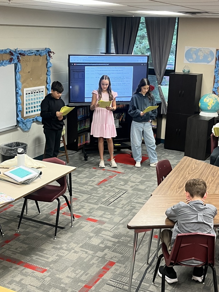Students reading scripts for a Readers Theater