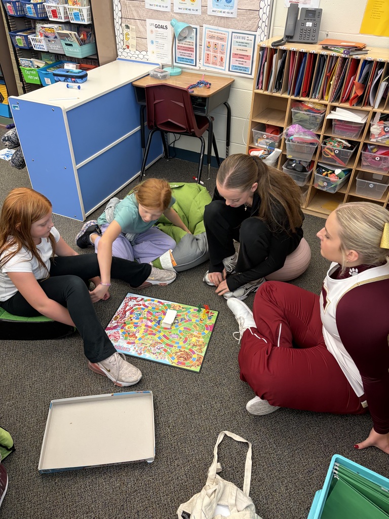 Students in a classroom doing a board game