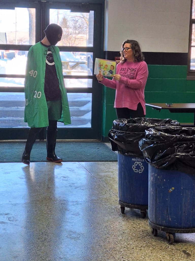 Zero The Hero reading a book about one hundred things on the 100th day of school.