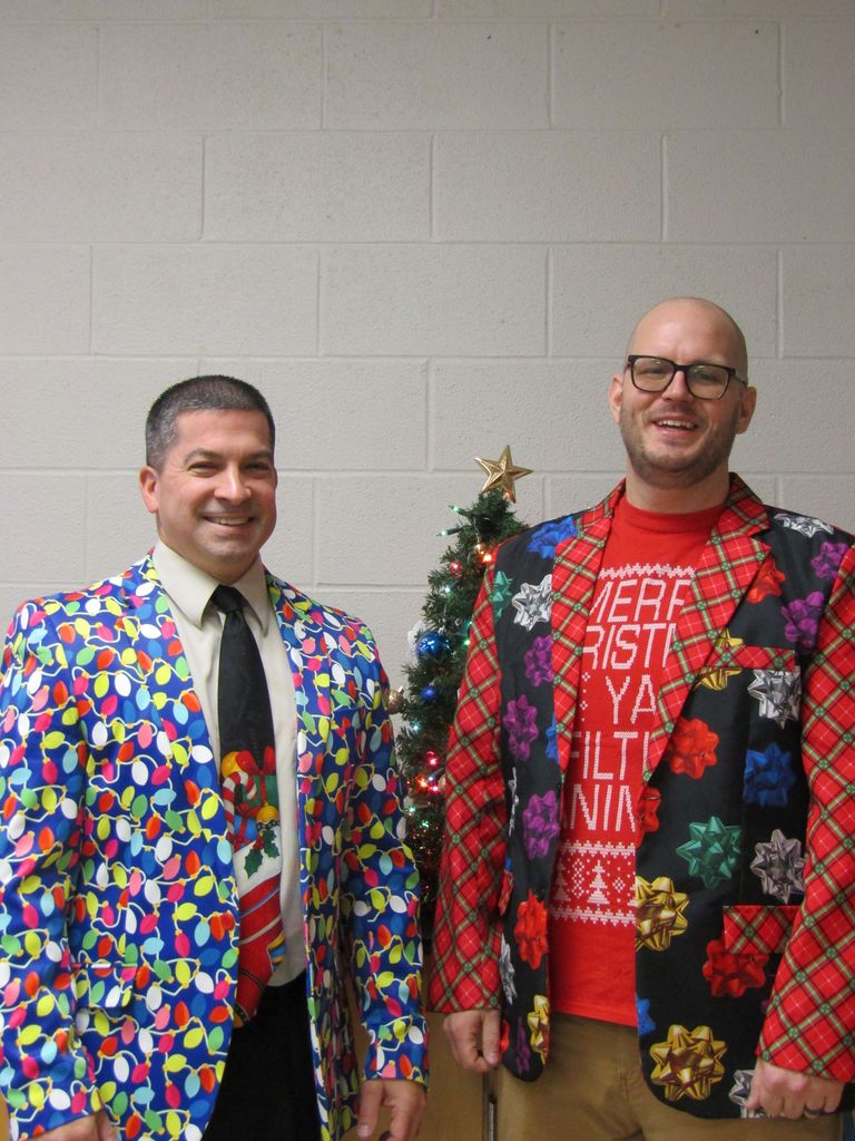 Two male teachers dressed in festive jackets