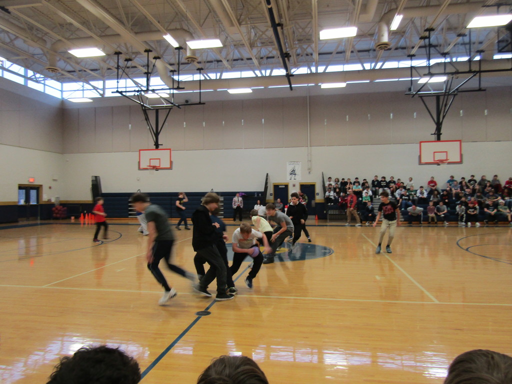 Students running to grab the dodgeballs