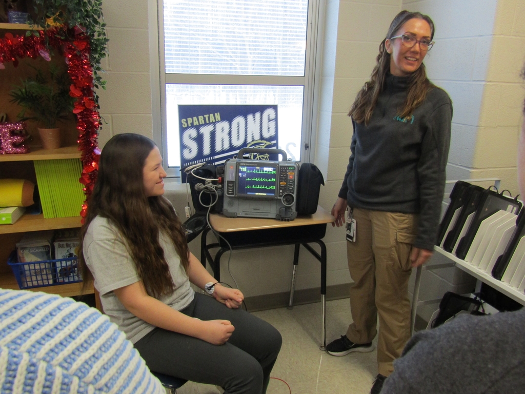 Student and Medical personnel checking vitals 