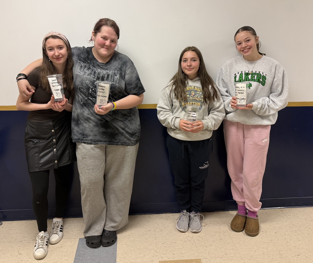 Students holding their Lake Vibes cups with their winning attendance slogans
