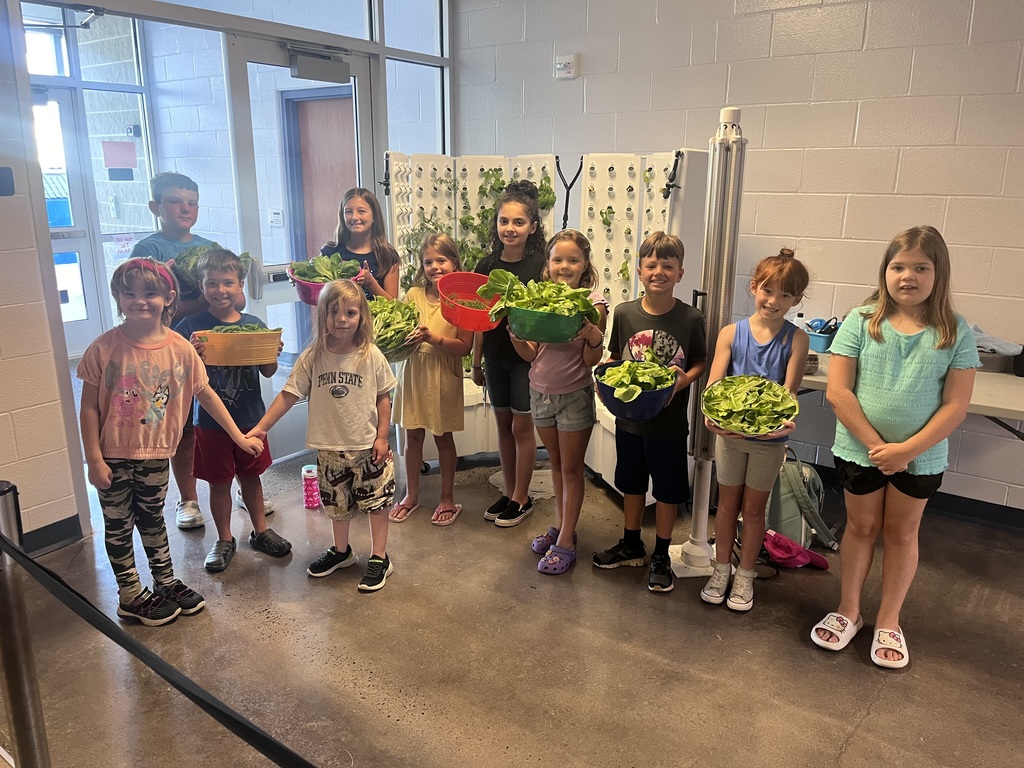 students with the food they harvested from the hydroponic garden