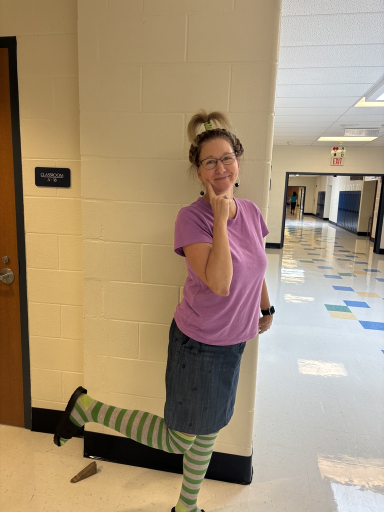Teacher posing with crazy hair and crazy socks