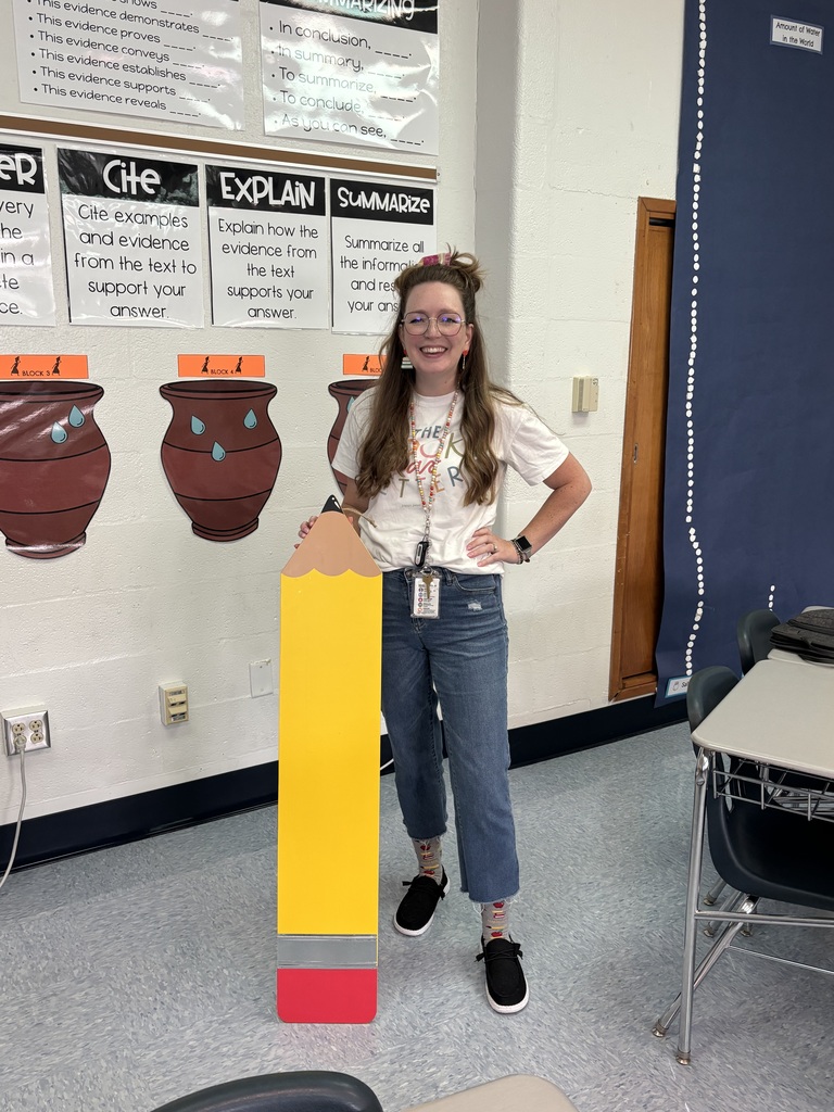 Teacher posing with giant pencil