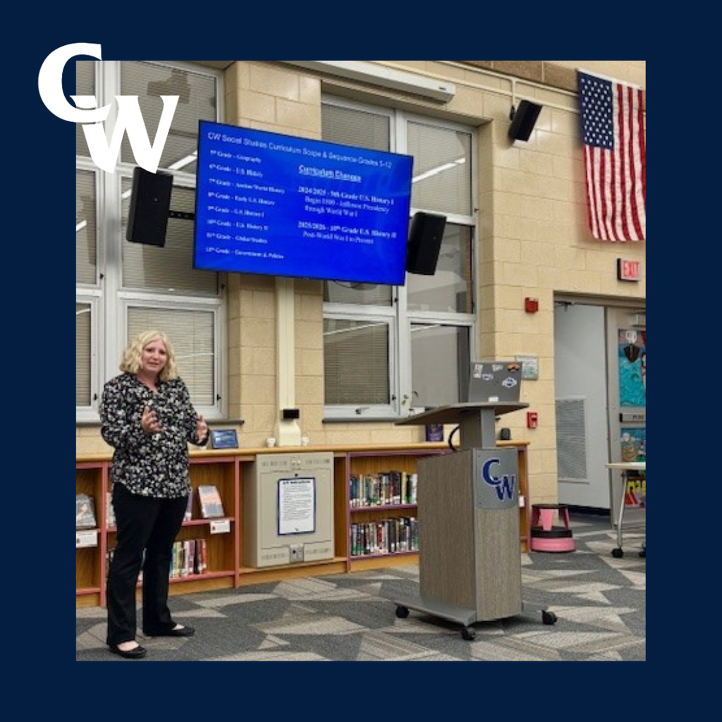 teacher presenting at curriculum committee meeting