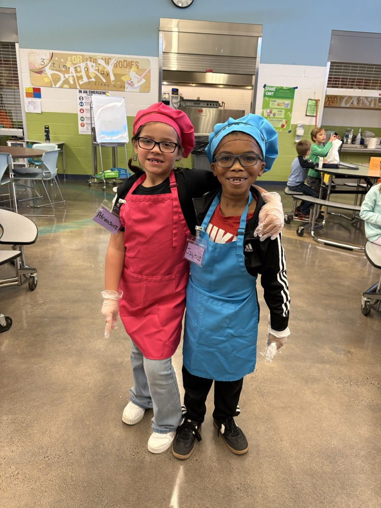 2 students helping in the cafeteria