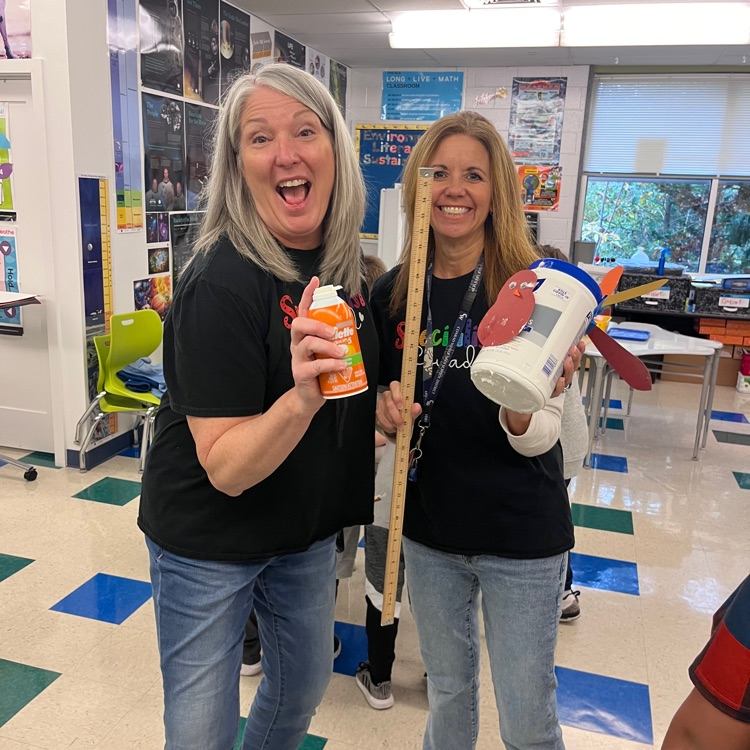 two teachers with supplies for a project
