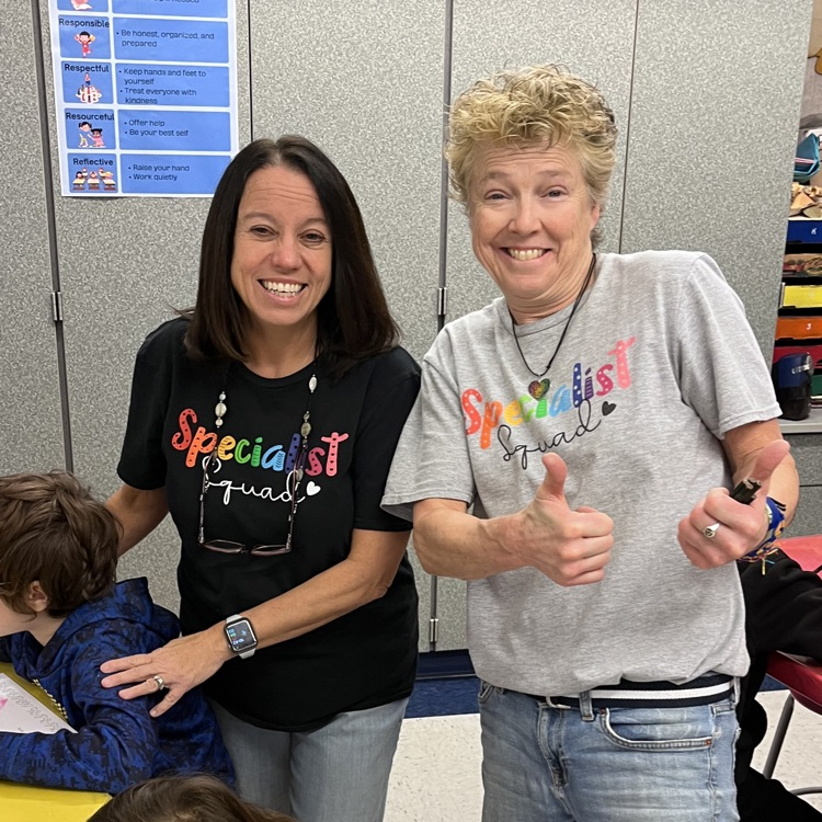 two teachers in matching shirts