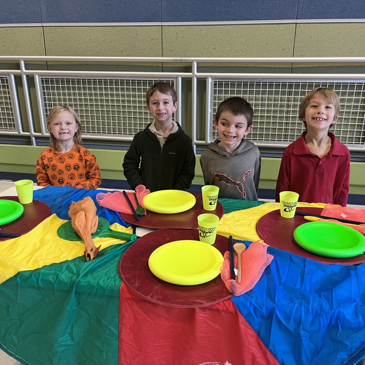 students with their table set up for Thanksgiving dinner