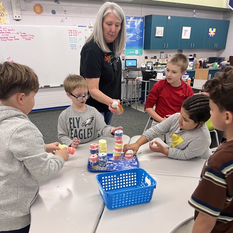 student building their tower with pool noodles and shaving cream for turkey