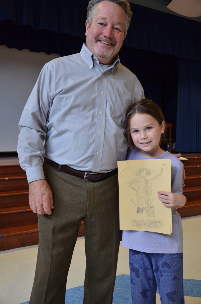 Lee Harper with a student holding their drawing