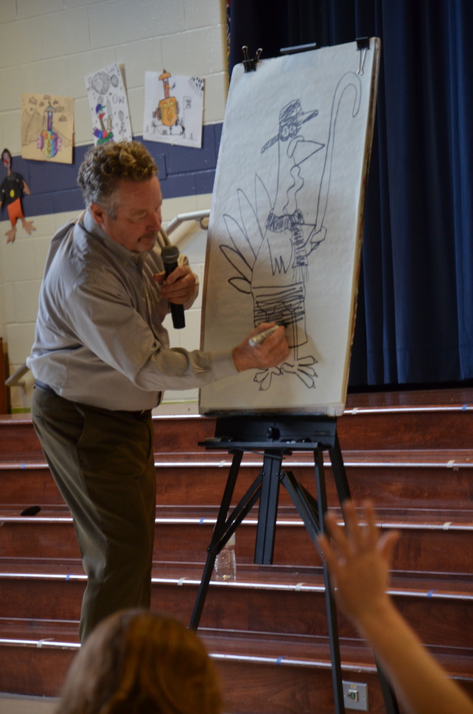 Author drawing a picture of a disguised turkey on an easel