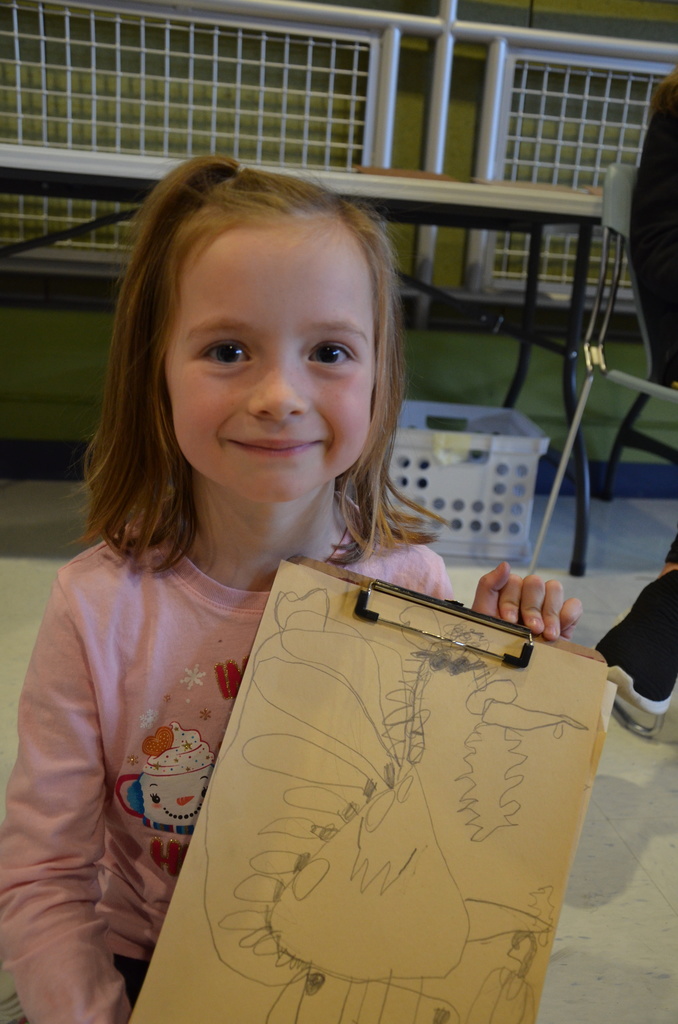 Student holding her drawing
