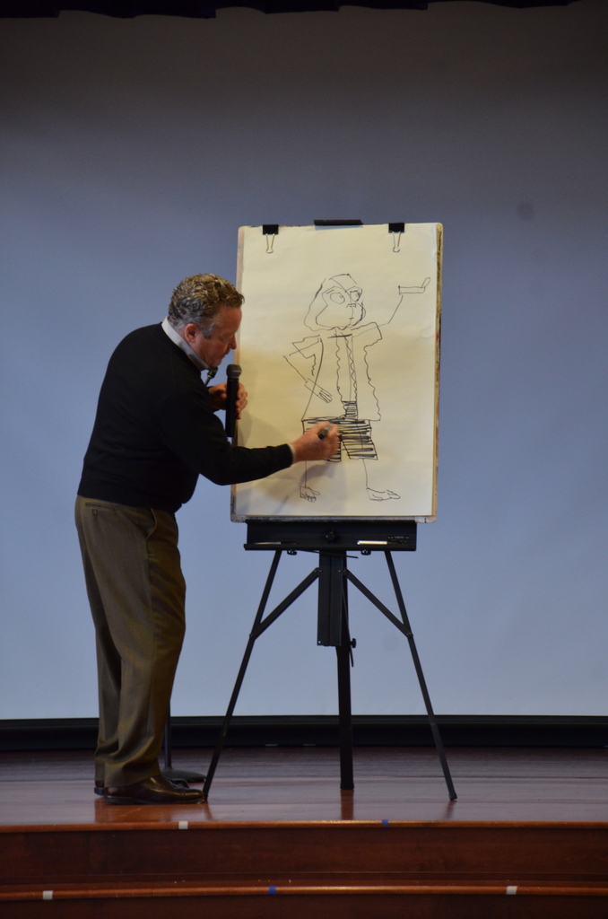Author drawing a picture on an easel