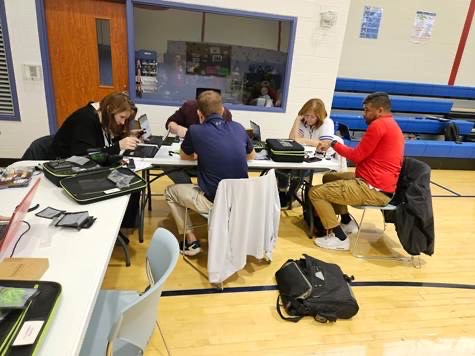 educators sitting around a table planning to fly a drone