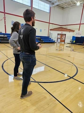 educators sitting around a table planning to fly a drone