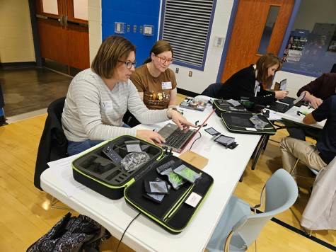 educators sitting around a table planning to fly a drone
