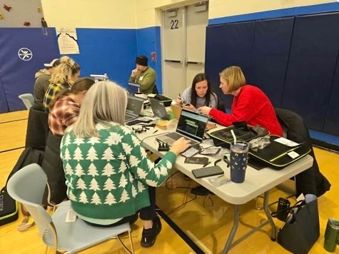educators sitting around a table planning to fly a drone