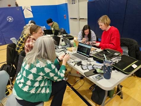 educators sitting around a table planning to fly a drone