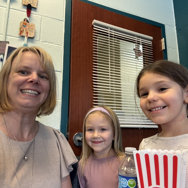 student(s) with principal eating popcorn