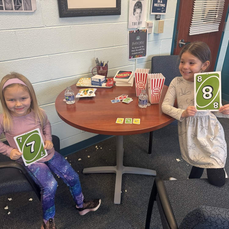 student(s) with principal eating popcorn