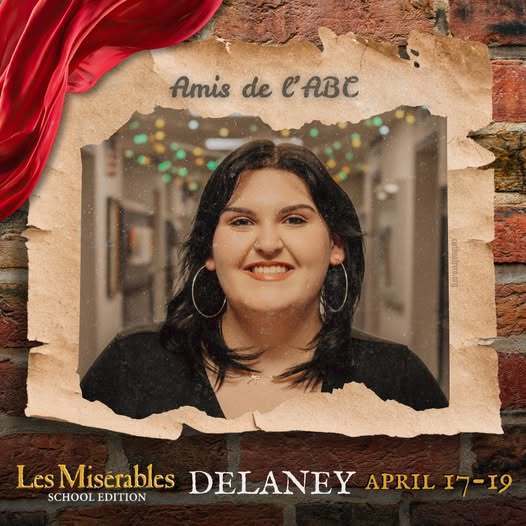 A promo graphic for Les MisΓ©rables: School Edition featuring a student cast memberβs headshot. The student is centered in a softly lit indoor setting and framed within a torn parchment-style border against a brick wall background, with a red draped fabric accent in the corner. The top of the image reads βAmis de lβABC,β and the bottom includes the show title and performance dates: April 17β19.