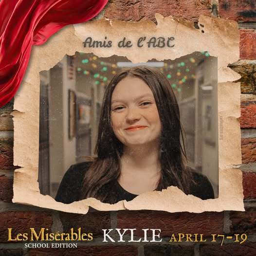 A promo graphic for Les MisΓ©rables: School Edition featuring a student cast memberβs headshot. The student is centered in a softly lit indoor setting and framed within a torn parchment-style border against a brick wall background, with a red draped fabric accent in the corner. The top of the image reads βAmis de lβABC,β and the bottom includes the show title and performance dates: April 17β19.