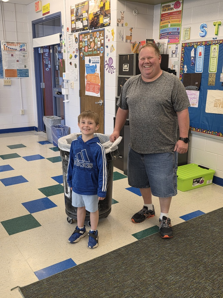 Mr. Hernley with a student in a classroom 