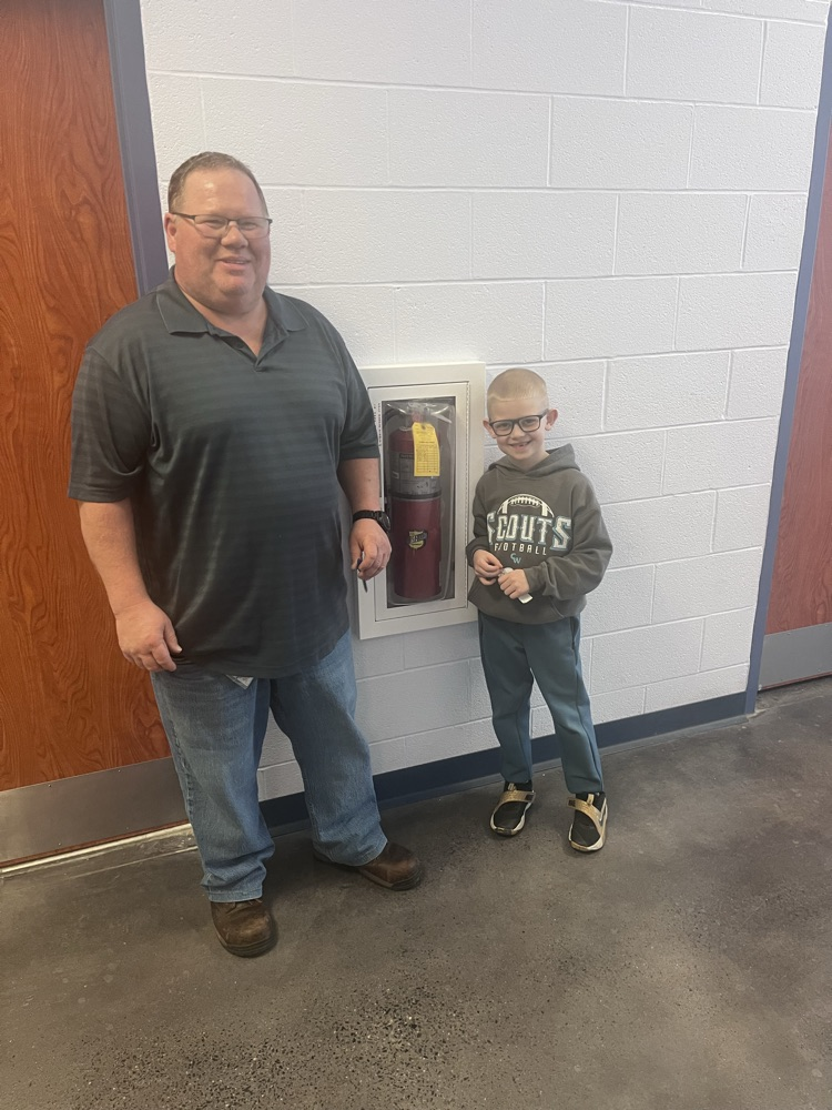 Mr Hernley and a student by a fire extinguisher 