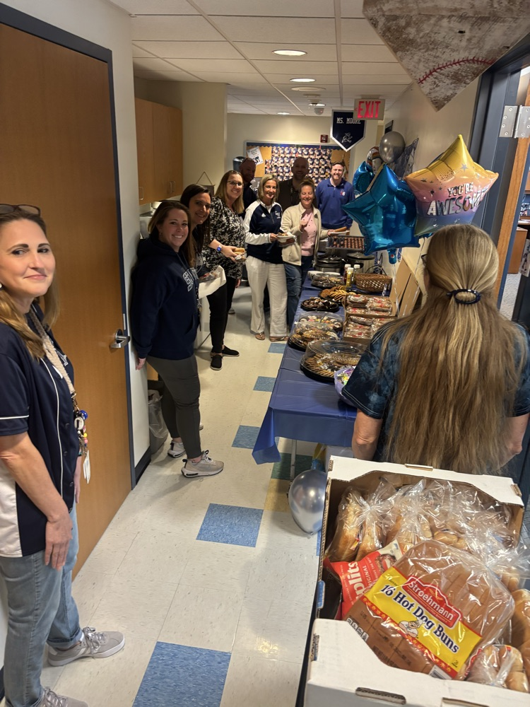 staff getting snacks from a table 
