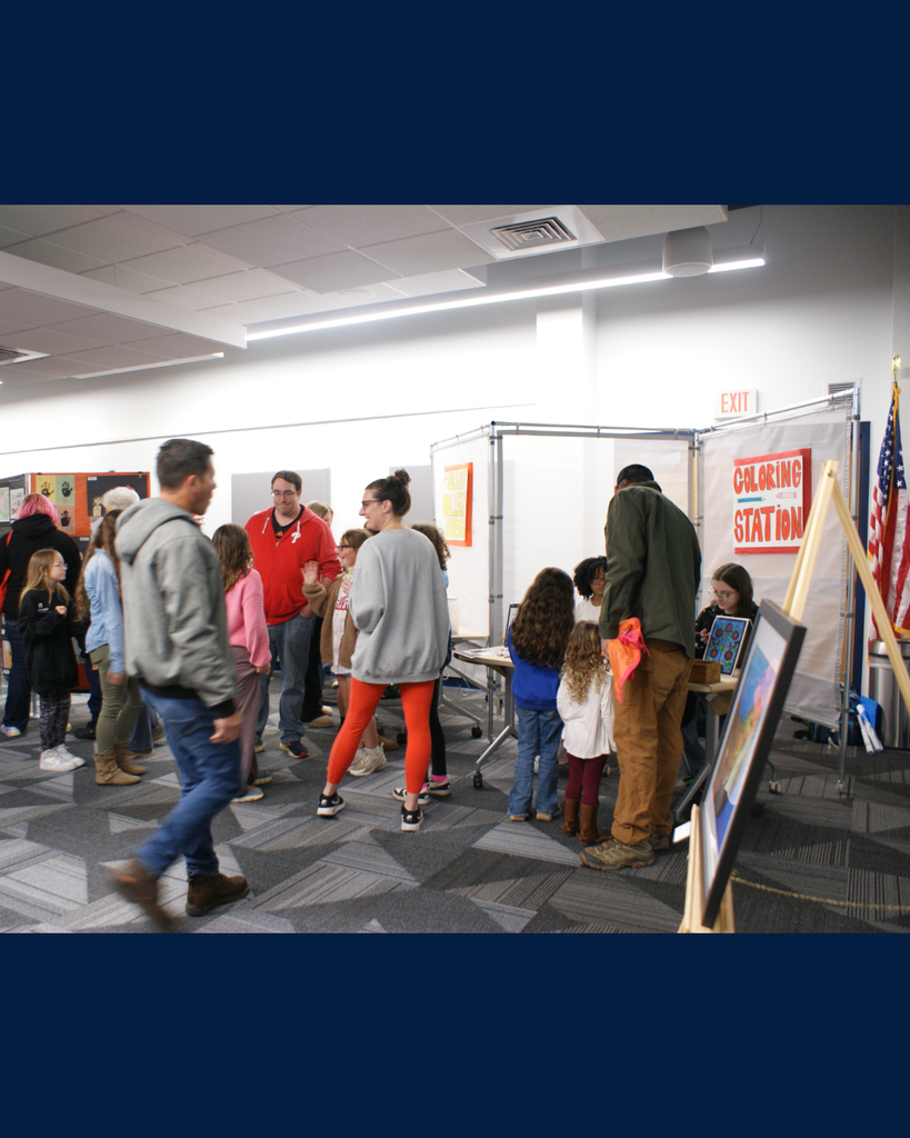 Photographs of families and community members viewing student artwork at the District Wide art show