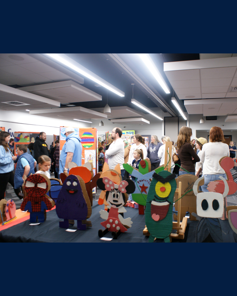 Photographs of families and community members viewing student artwork at the District Wide art show