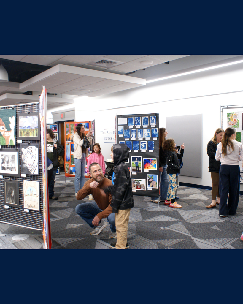 Photographs of families and community members viewing student artwork at the District Wide art show