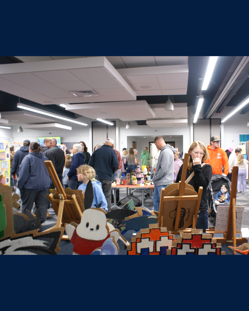 Photographs of families and community members viewing student artwork at the District Wide art show